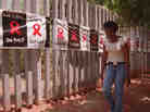 A woman walks past a banner placed around the perimeter of the Rand Afrikaans University in Johannesburg on World AIDS Day. The university used the banner to raise public awareness about AIDS and the devastating toll the disease has had in South Africa. A woman walks past a banner placed around the perimeter of the Rand Afrikaans University in Johannesburg on World AIDS Day. The university used the banner to raise public awareness about AIDS and the devastating toll the disease has had in South Africa.