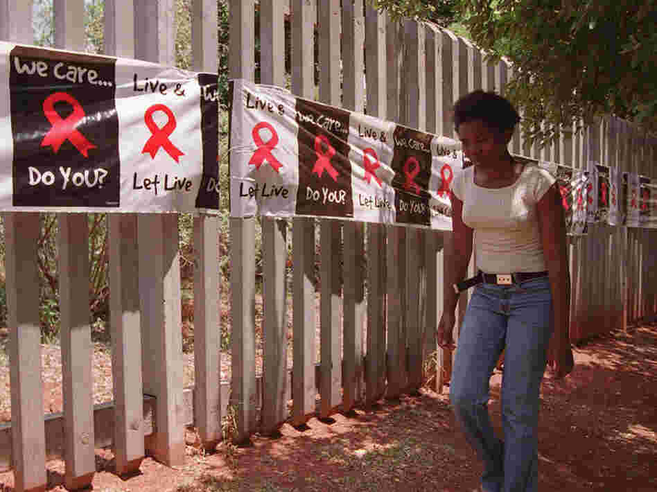 A woman walks past a banner placed around the perimeter of the Rand Afrikaans University in Johannesburg on World AIDS Day. The university used the banner to raise public awareness about AIDS and the devastating toll the disease has had in South Africa. 
