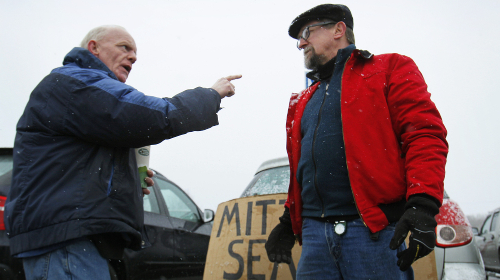Chris McDonough, a Republican (left), and Robert O'Brien, a Democrat, argue about political issues outside a caucus in Portland, Maine, in February.