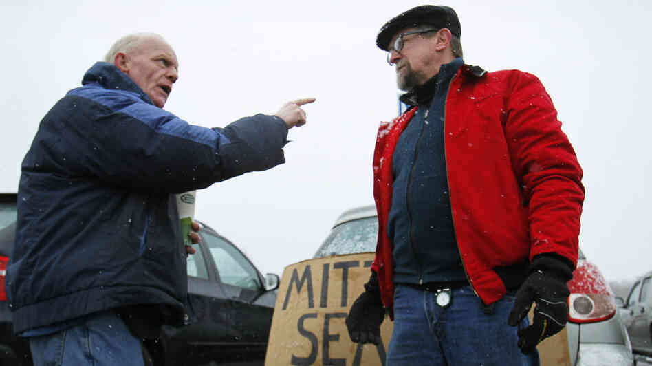 Chris McDonough, a Republican (left), and Robert O'Brien, a Democrat, argue about political issues outside a caucus in Portland, Maine, in February.