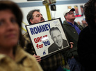A supporter of Republican presidential candidate Mitt Romney holds a vintage campaign poster of Romney's father, George Romney, in Albion, Mich. A supporter of Republican presidential candidate Mitt Romney holds a vintage campaign poster of Romney's father, George Romney, in Albion, Mich.