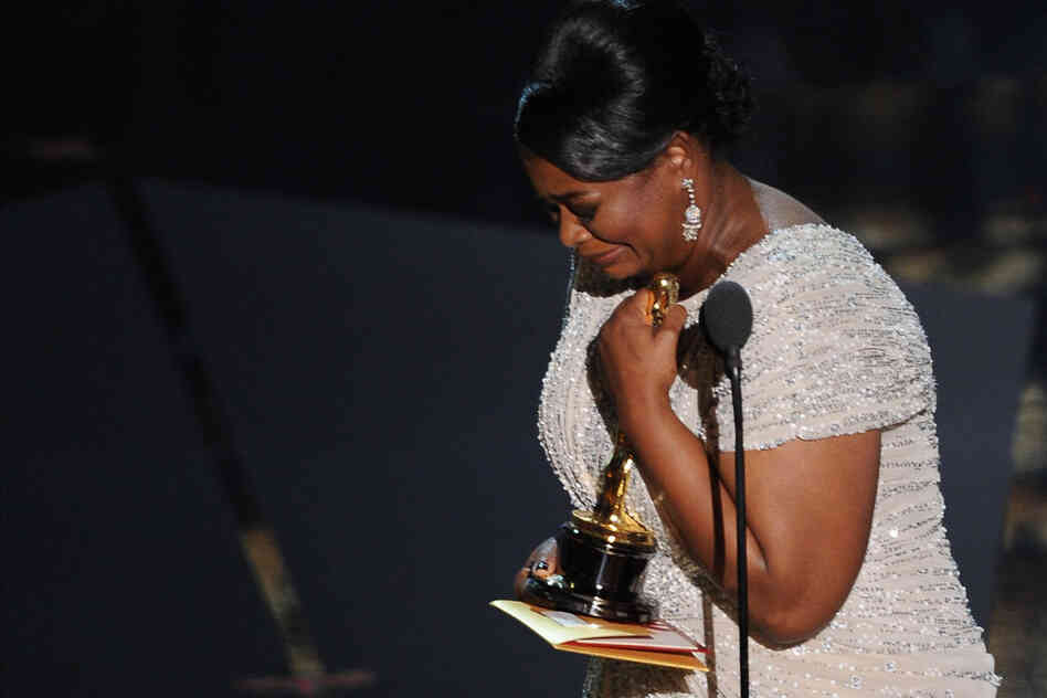 Octavia Spencer tearfully accepts the award for Best Supporting Actress for her portrayal of Minny Jackson, a housemaid in 1960s Mississippi, in the film adaptation of Kathryn Stockett's "The Help". 