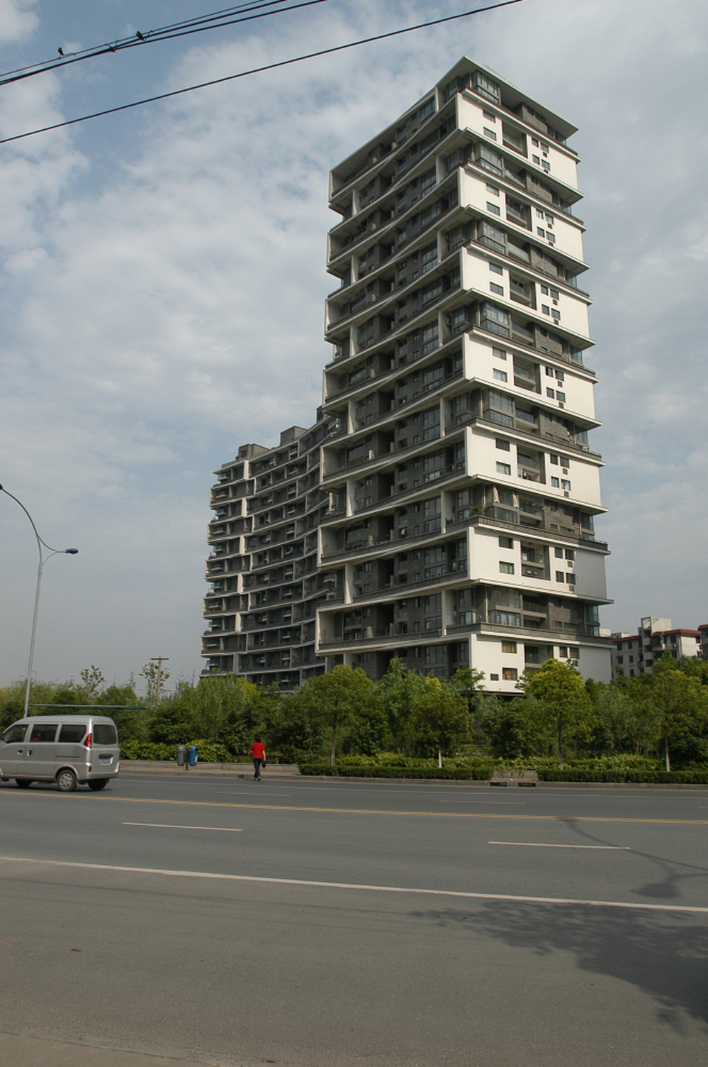  In Wang's Vertical Courtyard Apartments, residents plant small trees that are special to them, to differentiate their tower from others.