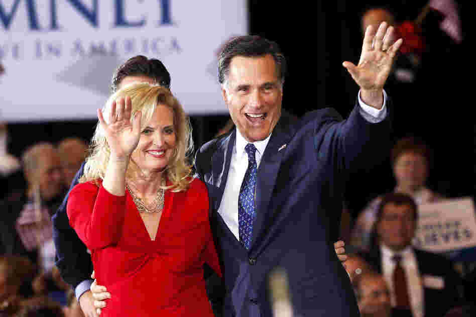Detroit native Mitt Romney greets supporters with wife Ann in Novi, Mich., after squeaking out a win in Tuesday's primary. He also won Arizona. 