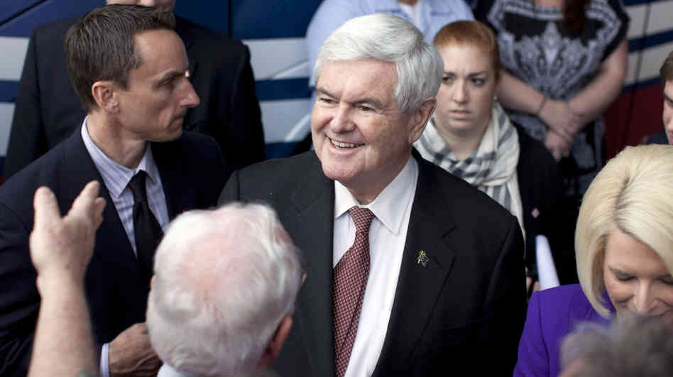 Newt Gingrich shakes hands during a campaign rally Tuesday in Rome, Ga. 