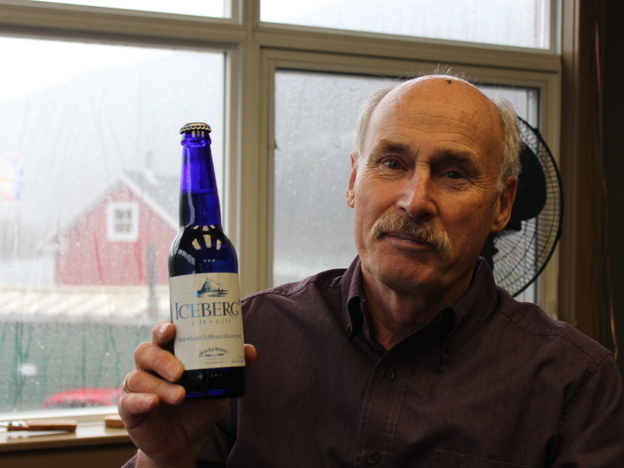 Charlie Rees, who gives tours of Quidi Vidi Brewing Co., holds a bottle of Iceberg beer.