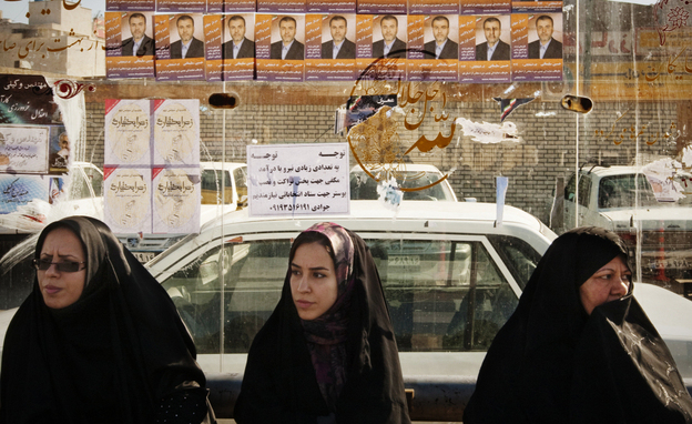 Women sit at a bus stop under election posters in Qom, about 75 miles south of Iran's capital, Tehran, on Tuesday. Iran's parliamentary elections on Friday are expected to be a contest between various conservative factions. Many candidates seeking change have been barred from running. Women sit at a bus stop under election posters in Qom, about 75 miles south of Iran's capital, Tehran, on Tuesday. Iran's parliamentary elections on Friday are expected to be a contest between various conservative factions. Many candidates seeking change have been barred from running.