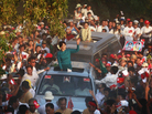 Supporters greet Myanmar's pro-democracy icon Aung San Suu Kyi, atop her vehicle, as she arrives at an election campaign rally in Thongwa village, Myanmar, on Sunday. The country's new government is holding legislative elections on April 1. Supporters greet Myanmar's pro-democracy icon Aung San Suu Kyi, atop her vehicle, as she arrives at an election campaign rally in Thongwa village, Myanmar, on Sunday. The country's new government is holding legislative elections on April 1.