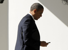 President Obama appears to check smartphone as he heads for the Oval Office after speaking to the UAW, Tuesday, Feb. 28, 2012. President Obama appears to check smartphone as he heads for the Oval Office after speaking to the UAW, Tuesday, Feb. 28, 2012.