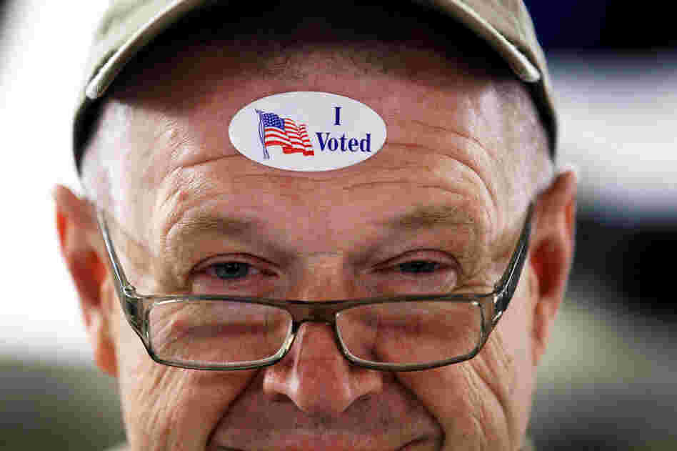John Vandermark wears an "I Voted" sticker after voting in the Michigan primary at Royal Oak Farmers Market, in Royal Oak. 