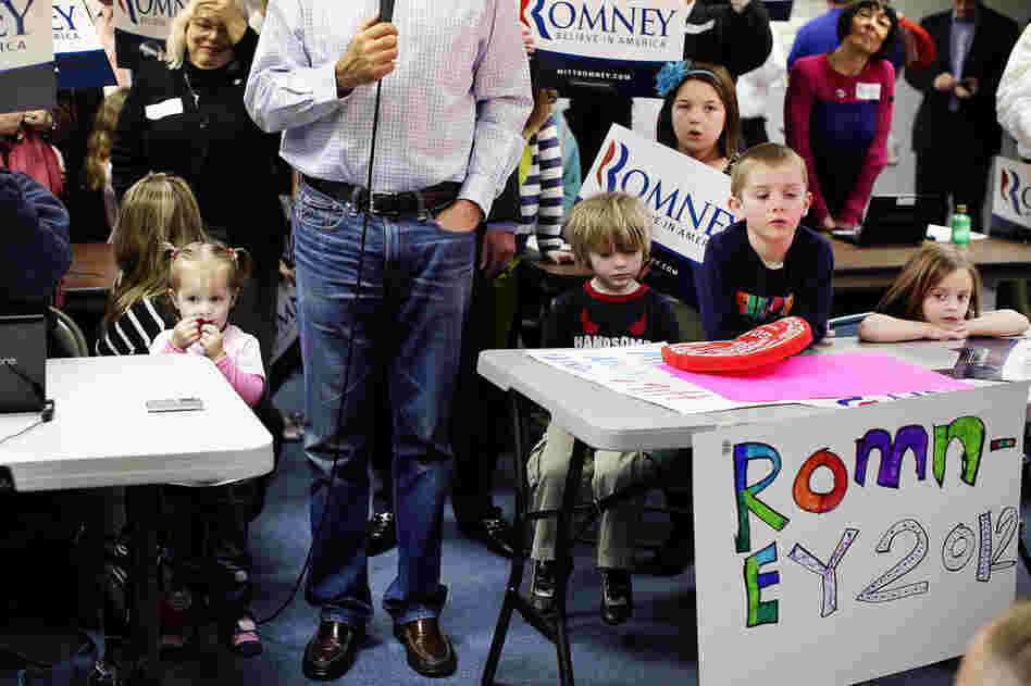 Surrounded by children, Mitt Romney speaks to the media after a visit to his Michigan campaign headquarters in Livonia. 