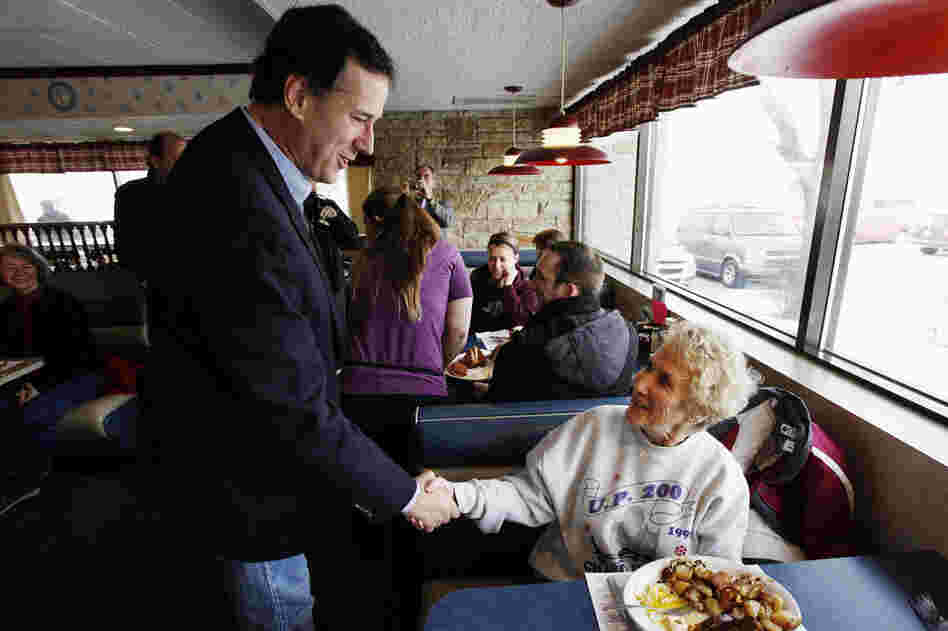 Santorum greets diners at New Beginnings Restaurant in Kentwood, Mich. He lost Tuesday but is atop polls in several states with March 6 primaries. 