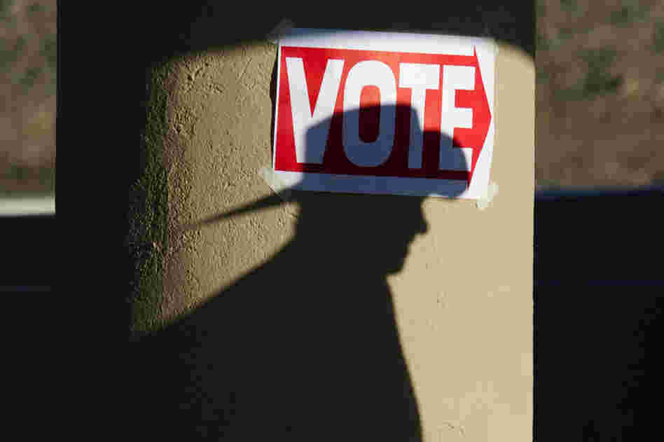 A Republican voter goes to the polls at the Wickenburg Community Center in Wickenburg, Ariz., on Tuesday. 