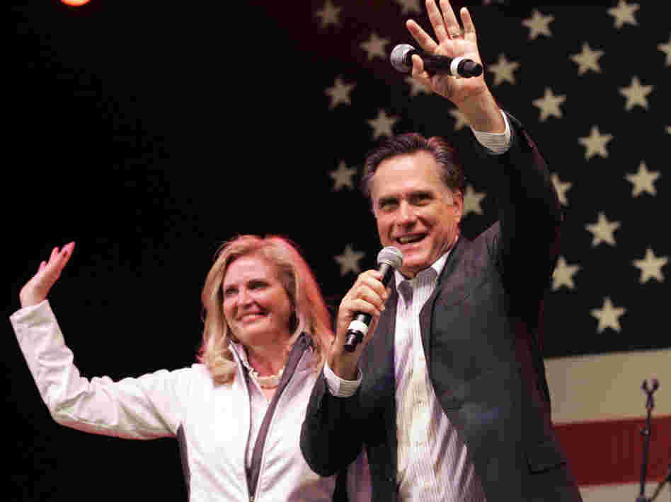 In a final bit of campaigning before Tuesday's vote, Mitt Romney and his wife, Ann, wave to his supporters during a campaign stop in Royal Oak, Mich., on Monday night. 