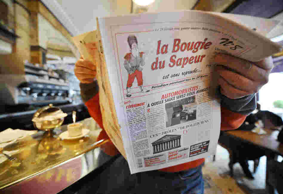 A man reads a copy of the satirical newspaper La Bougie du Sapeur (The Sapper's Candle), published every leap day, in a Parisian cafe on Feb. 29, 2008. The paper's tagline is "without reproach."