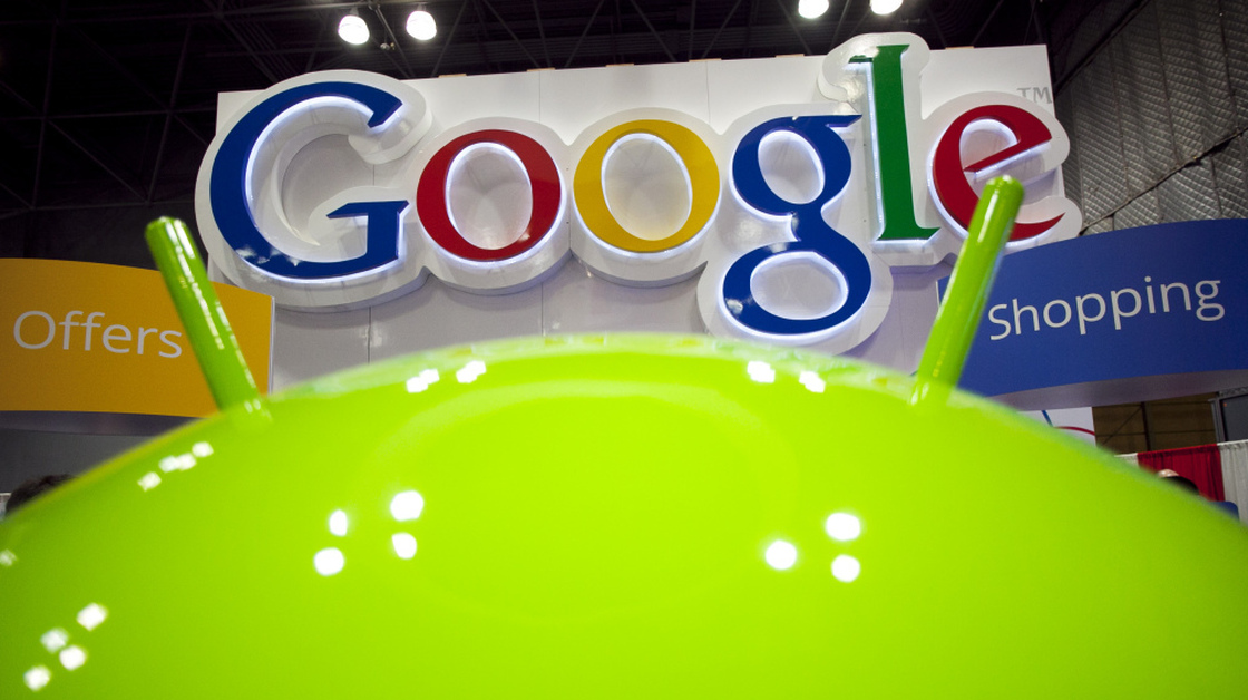 A sign for Google is displayed behind the Google android robot, at the National Retail Federation in New York. Google is planning to roll out a new privacy policy Thursday.