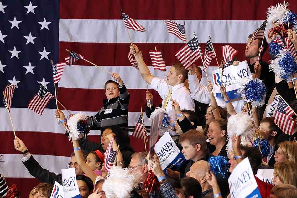 Romney supporters cheer during a primary night gathering at the Suburban Collections Showplace in Novi, Mich. 