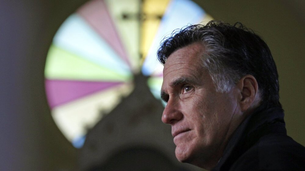 Republican presidential candidate Mitt Romney pauses during a visit to St. Paul's Lutheran Church while campaigning in Berlin, N.H., on Dec. 22.