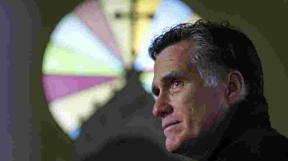 Republican presidential candidate Mitt Romney pauses during a visit to St. Paul's Lutheran Church while campaigning in Berlin, N.H., on Dec. 22.