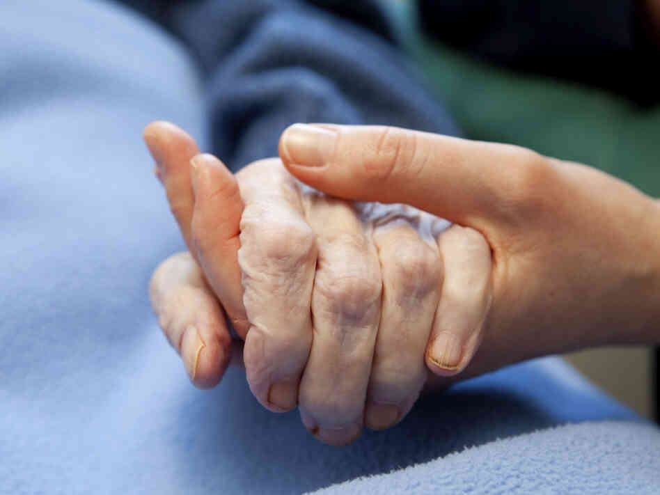 A young hand touches and holds an old wrinkled hand. In the first hour, author Sandra Tsing Loh talks about the challenges of caring for her aging father. A young hand touches and holds an old wrinkled hand. In the first hour, author Sandra Tsing Loh talks about the challenges of caring for her aging father.