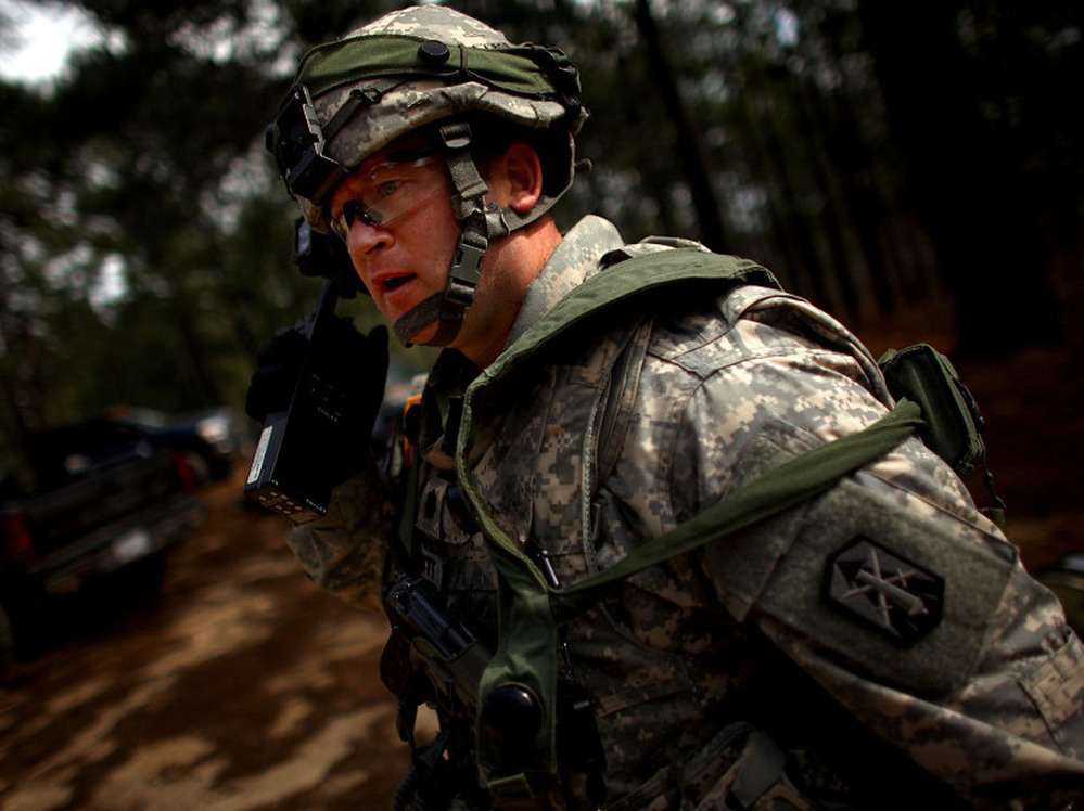 Lt. Col. Mark Schmitt, who will be among a group of U.S. military trainers heading to Afghanistan soon, calls out orders during a mock attack on the model Afghan village at the U.S. military base in Fort Polk, La. 