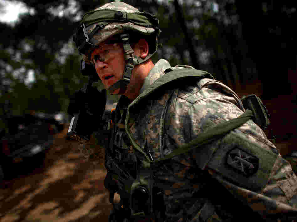 Lt. Col. Mark Schmitt, who will be among a group of U.S. military trainers heading to Afghanistan soon, calls out orders during a mock attack on the model Afghan village at the U.S. military base in Fort Polk, La. 
