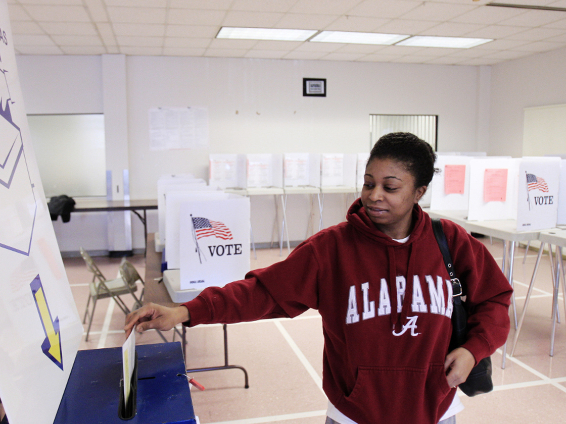 As the candidates head into Super Tuesday on March 6, Ohio is shaping up as the biggest prize. Sheenae Westmoreland drops her ballot into the box after early voting in Cleveland on Jan. 31. Early in-person voting is set to continue until March 2.