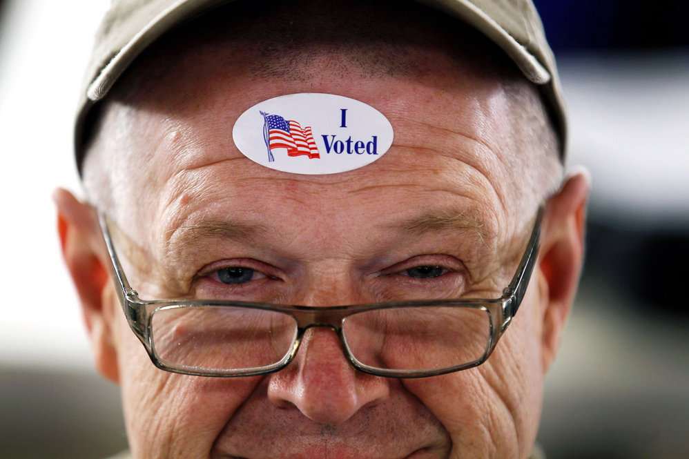 John Vandermark wears an "I Voted" sticker after voting in the Michigan primary at Royal Oak Farmers Market, in Royal Oak. 
