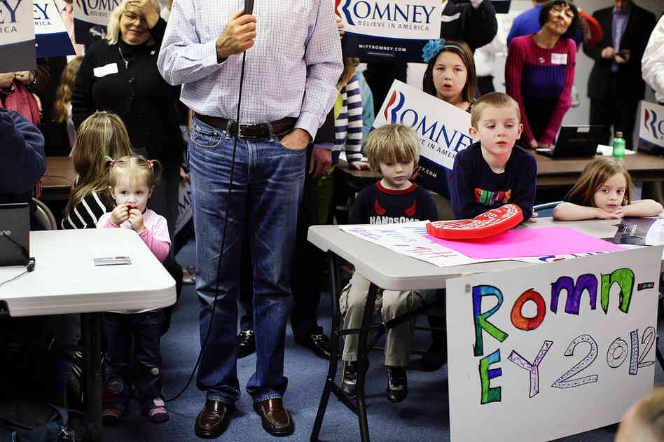 Surrounded by children, Mitt Romney speaks to the media after a visit to his Michigan campaign headquarters in Livonia. 