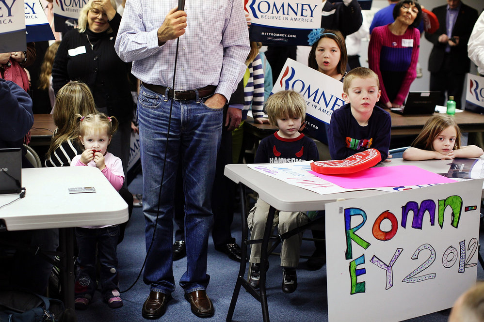 Surrounded by children, Mitt Romney speaks to the media after a visit to his Michigan campaign headquarters in Livonia. 