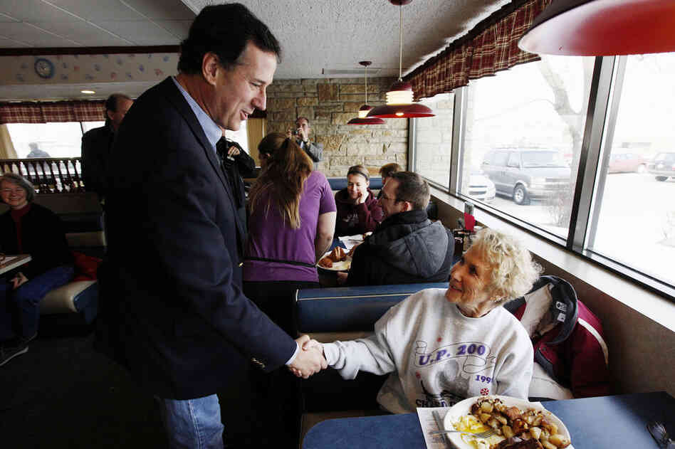 Santorum greets diners at New Beginnings Restaurant in Kentwood, Mich. He lost Tuesday but is atop polls in several states with March 6 primaries. 