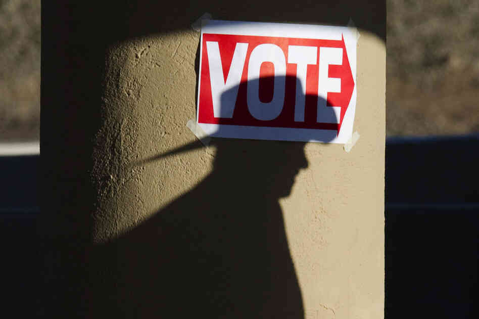 A Republican voter goes to the polls at the Wickenburg Community Center in Wickenburg, Ariz., on Tuesday. 