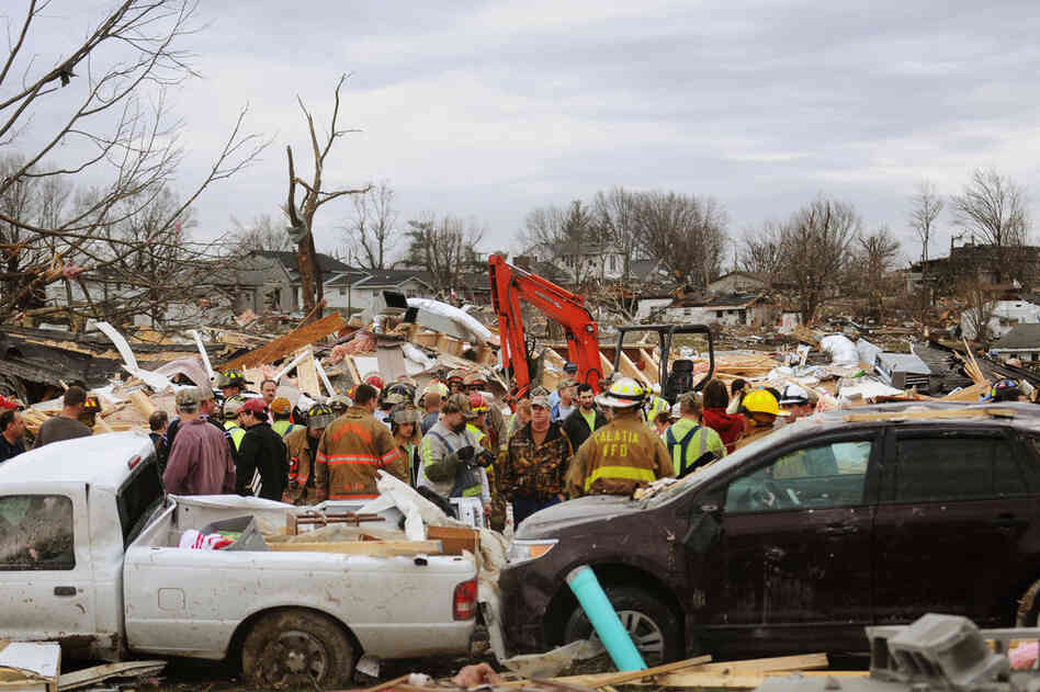 Emergency responders work to clear debris in a Harrisburg, Ill., neighborhood after a powerful storm lashed the Midwest on Wednesday. 