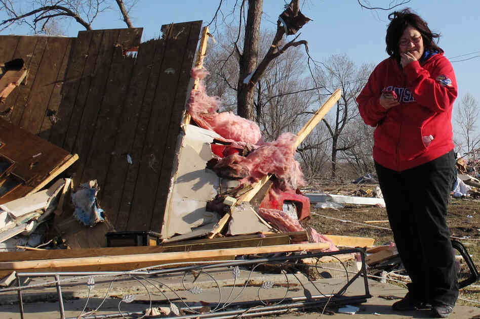 Tammy Woodyard surveys the wreckage of her father's home in Harveyville, Kan. 