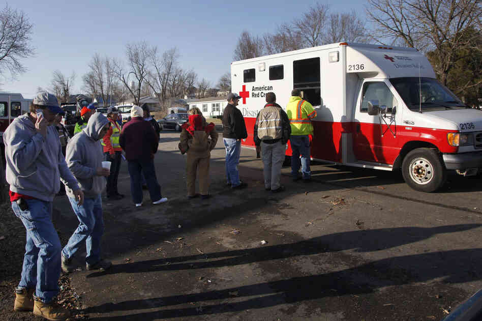 Residents and volunteers line up for food and drinks in Harveyville. 