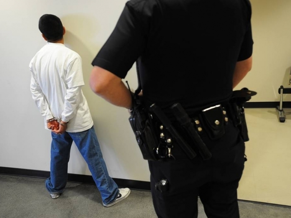 A Los Angeles police officer detains a San Pedro High School student in 2010 for truancy. After years of following a more punitive approach, Los Angeles is reconsidering how it handles students who skip class.