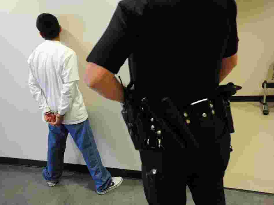 A Los Angeles police officer detains a San Pedro High School student in 2010 for truancy. After years of following a more punitive approach, Los Angeles is reconsidering how it handles students who skip class.