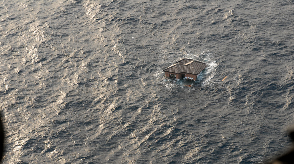 A Japanese home drifts in the Pacific Ocean, two days after the Japanese earthquake and tsunami. Photo provided by the U.S. Navy. 