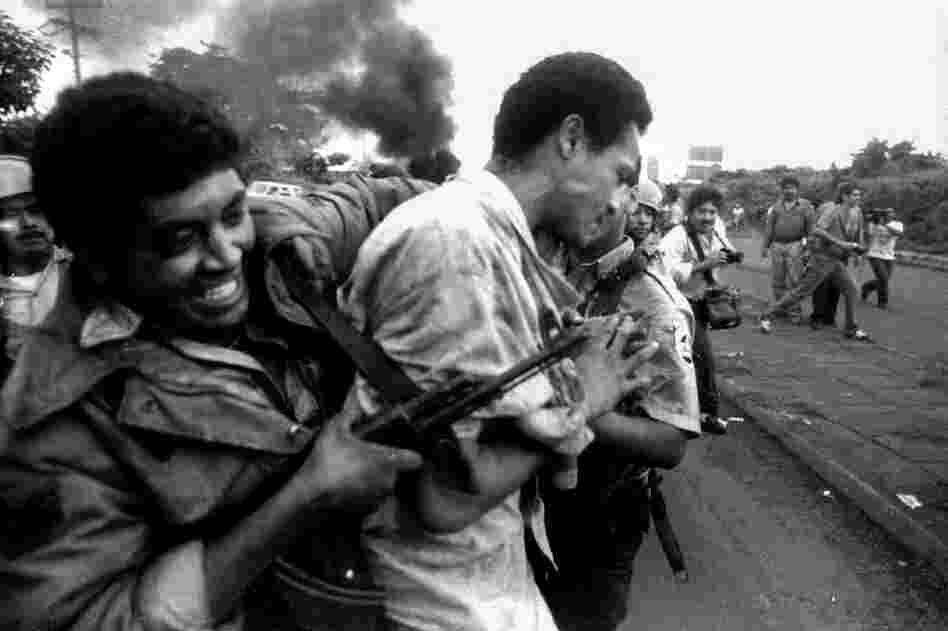 A man is arrested by a policeman armed with an AK-47 after violent clashes erupted during a 1993 general transportation strike in Managua, Nicaragua. 
