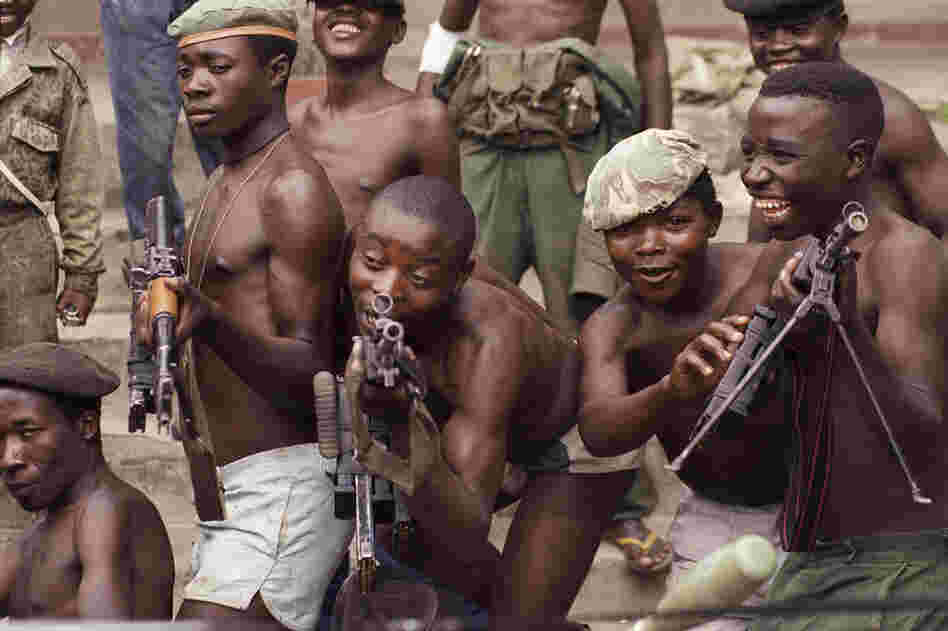 Young rebels in Zaire, now called the Democratic Republic of Congo, play with their AK-47s in the city of Goma in 1996. 
