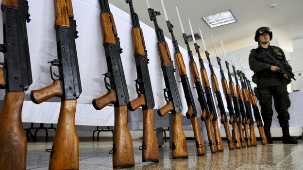 A Colombian police officer stands guard next to seized Chinese-made AK-47 replicas on Nov. 18, 2009. The guns have become so ubiquitous around the world that Russia's planned redesign may not do much to booster sales. A Colombian police officer stands guard next to seized Chinese-made AK-47 replicas on Nov. 18, 2009. The guns have become so ubiquitous around the world that Russia's planned redesign may not do much to booster sales.