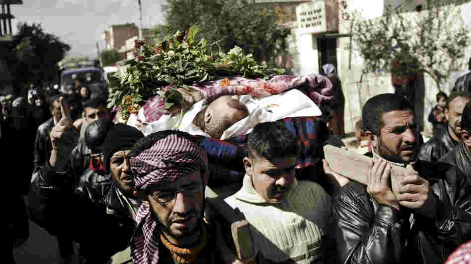 Syrian mourners in Qusayr, a few miles outside Homs, carry the body of a man killed by shrapnel, during his funeral on Tuesday. After a month-long assault by the Syrian army, rebels were forced to retreat from Homs on Thursday. 