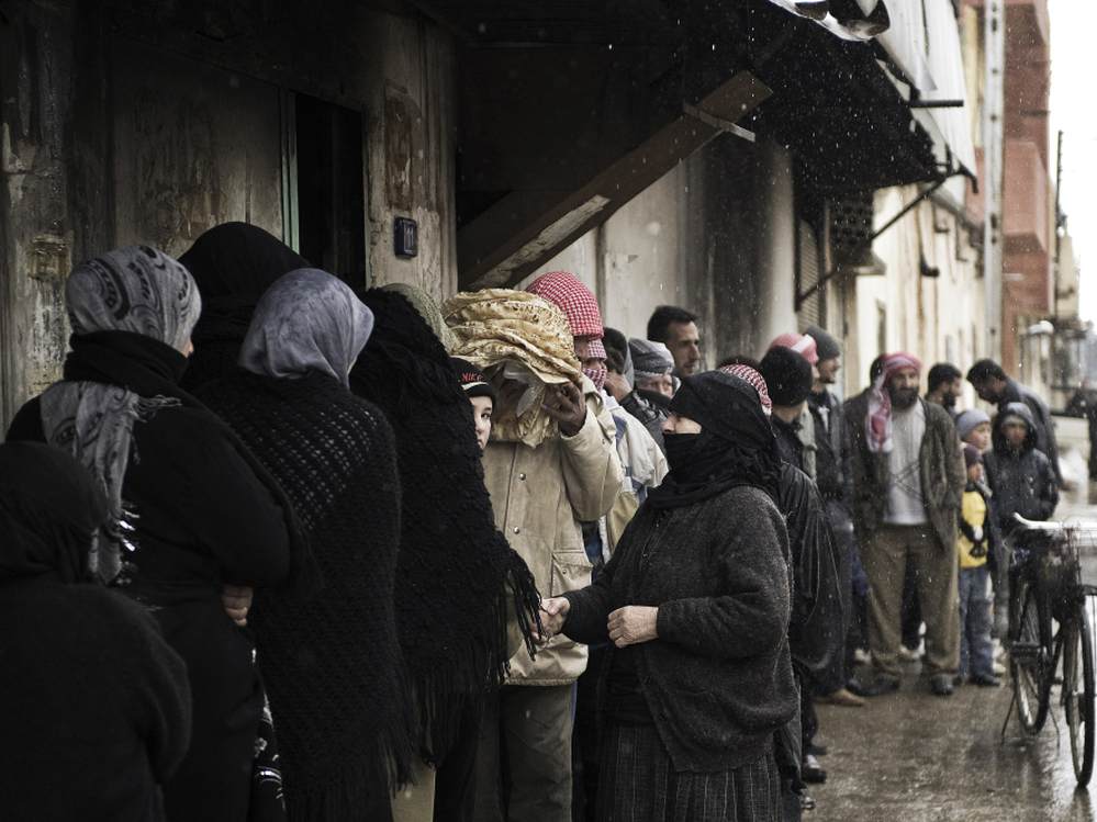 Syrians line up for bread outside a bakery in Qusayr on Thursday. After a month of heavy fighting in parts of Homs, civilians describe the conditions as miserable. 