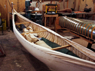 Goudie's last canoe hangs next to the form used to mold the wood. The unfinished canoe is weighted down with sandbags to keep the canvas taut. Goudie's last canoe hangs next to the form used to mold the wood. The unfinished canoe is weighted down with sandbags to keep the canvas taut.