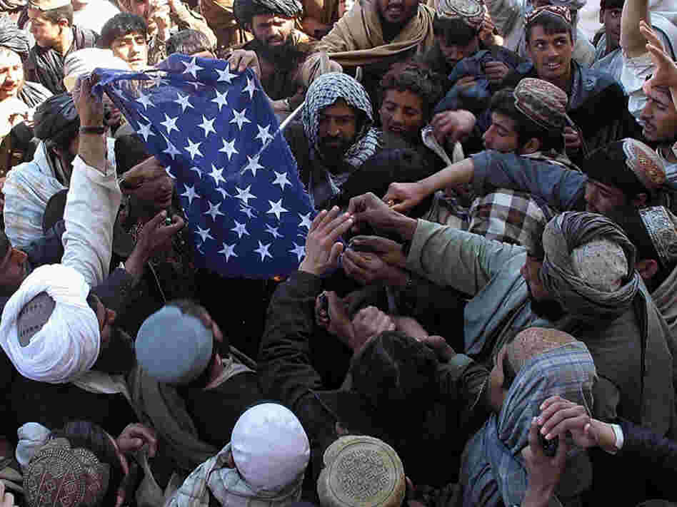 Feb. 23: Afghan demonstrators burn a U.S. flag during a protest in Afghanistan's Helmand province.