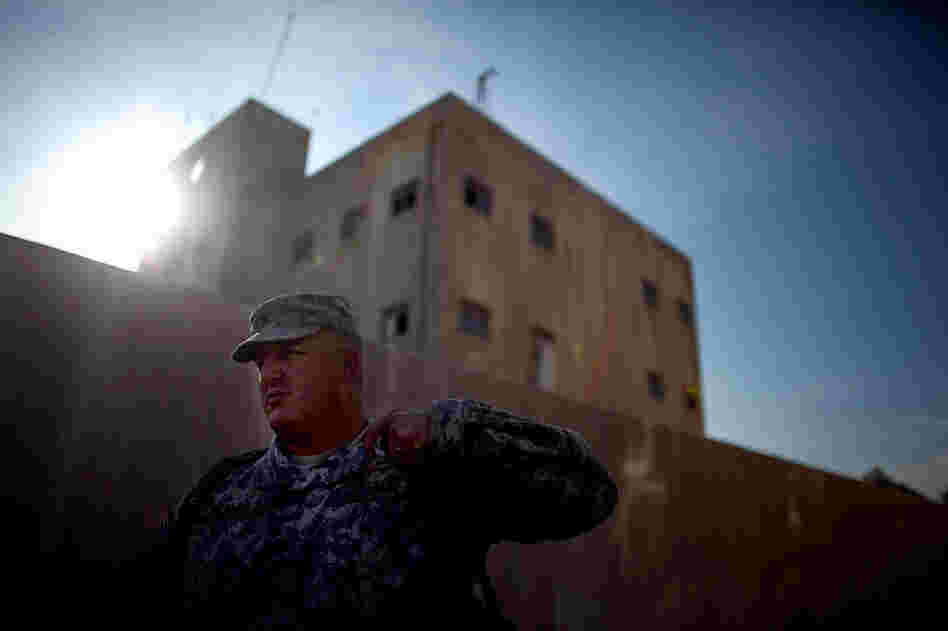 Col. Michael Kasales stands outside a mock Afghan village at Fort Polk, La., where U.S. Army soldiers are learning how to train Afghan security forces.