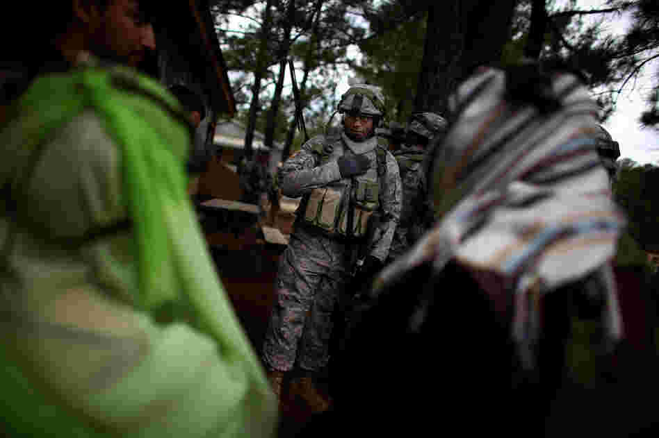 U.S. Capt. Donnell Mann greets female Afghan role-players.