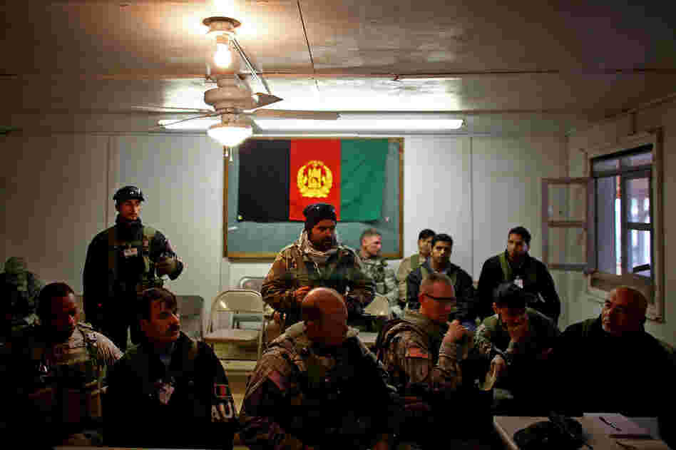 U.S. and Afghan security officers meet with civilian Afghan role-players.