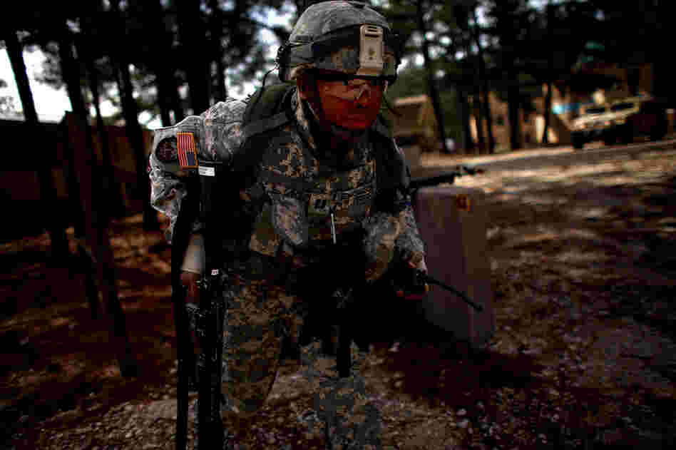 Capt. Marquay Edmondson runs for cover while trying to keep an eye on his Afghan counterparts during a gunfight.