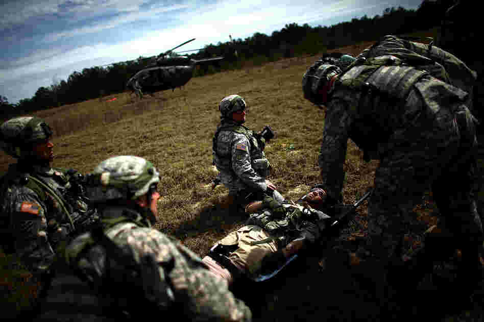 U.S. troops wait for the signal to bring a injured Afghan soldier out to a waiting helicopter.